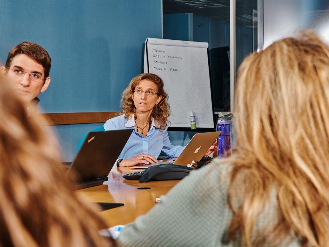 people working around conference table one person in focus